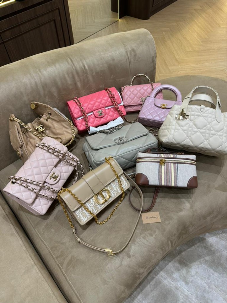 Chanel and Dior luxury handbags on display